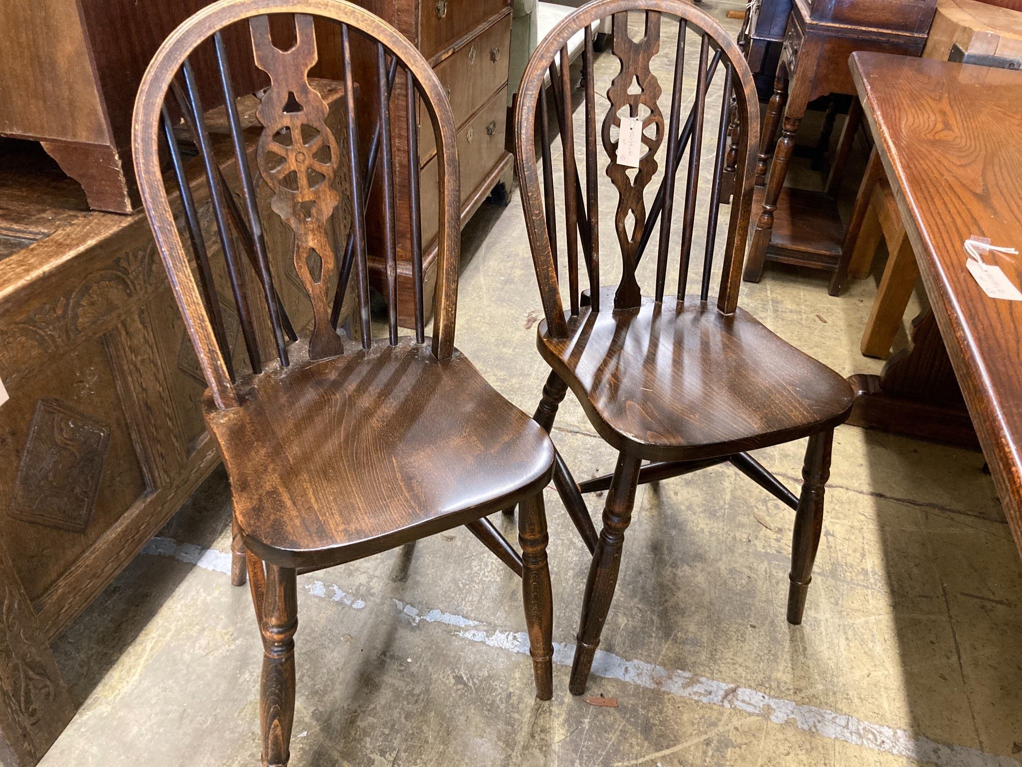 A 17th century style oak 'refectory' table on shaped trestle end supports, length 160cm, depth 83cm, height 75cm and four wheelback Windsor chairs